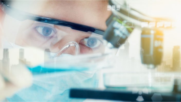 Researcher using a microscope