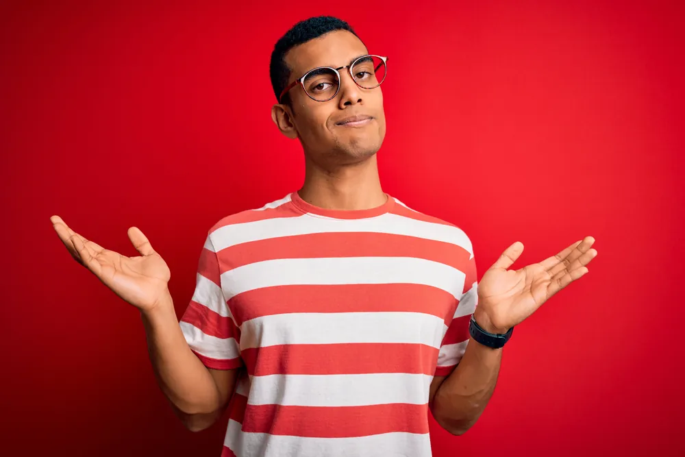 Image of a young man shrugging and showing a lack of concern.