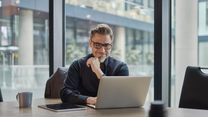 Older man using laptop