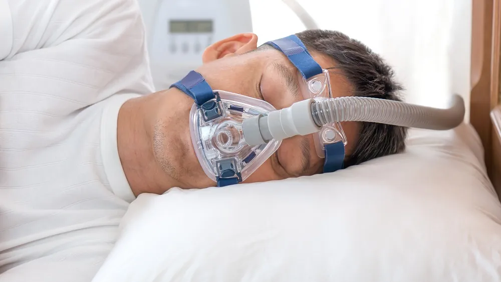 Sleeping man using CPAP